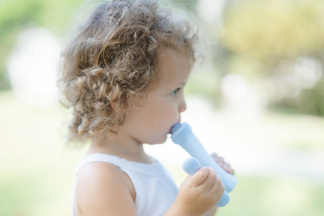 A Little girl enjoys a healthy, homemade meal in her Palmetto Pouch premium silicone pouch.